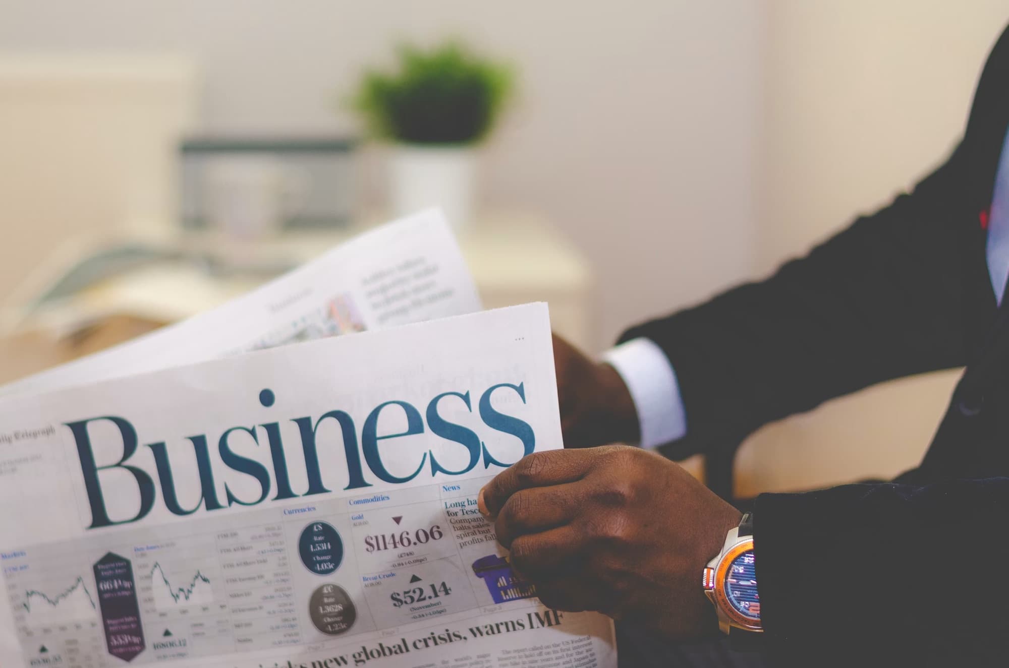 An executive reading the business pages of a newspaper